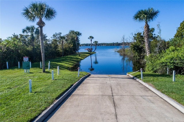 exterior space featuring a yard and a water view