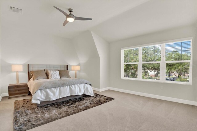 carpeted bedroom featuring vaulted ceiling and ceiling fan