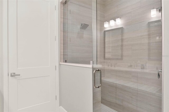 bathroom featuring a shower with door