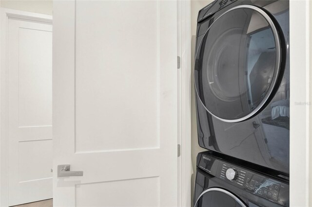 washroom with stacked washer / drying machine