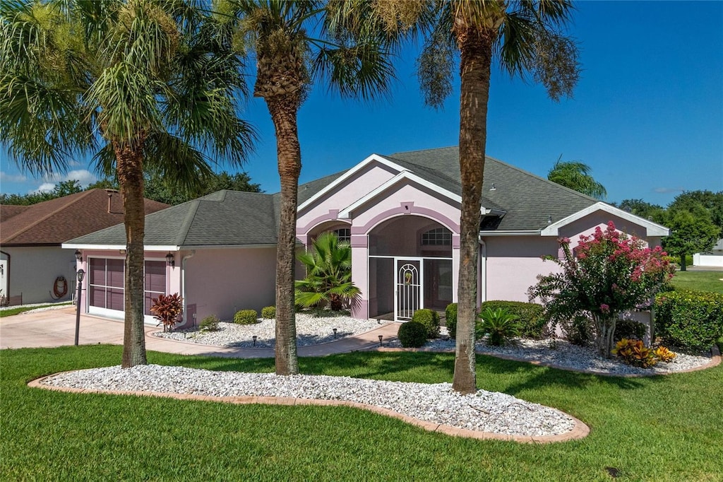 ranch-style home with a garage and a front yard