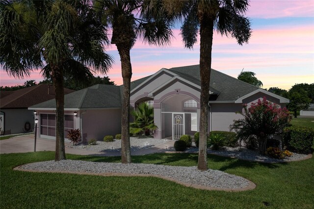 ranch-style home featuring a yard and a garage