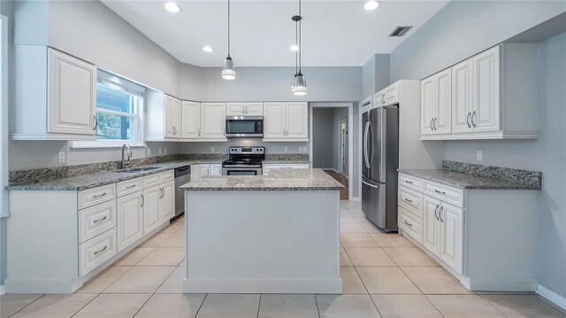 kitchen with light tile patterned flooring, appliances with stainless steel finishes, and white cabinets