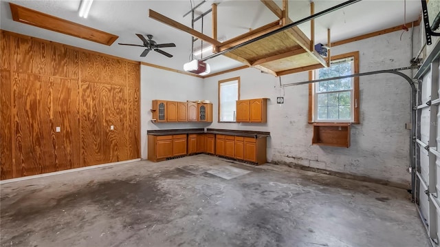 garage featuring wood walls and ceiling fan