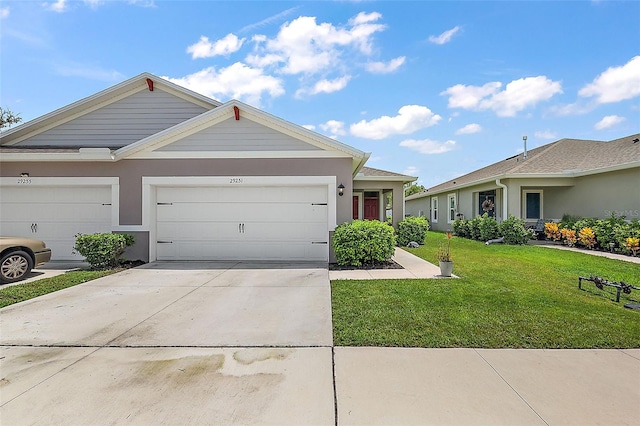 ranch-style home featuring a garage and a front yard