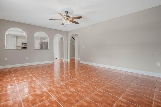 unfurnished room with a textured ceiling and ceiling fan