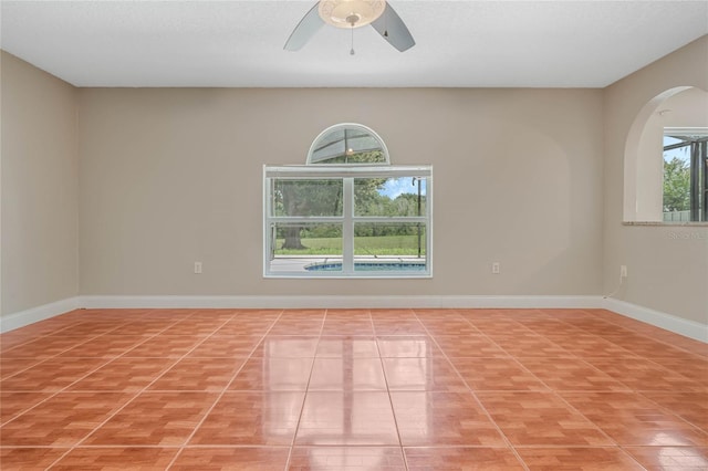 unfurnished room with tile patterned floors and ceiling fan