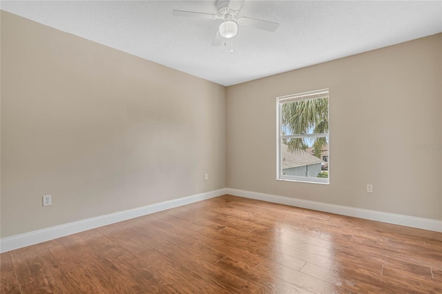 spare room with hardwood / wood-style flooring and ceiling fan