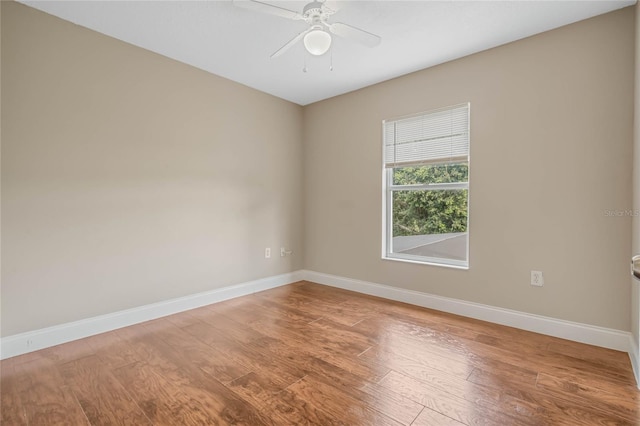 empty room with ceiling fan and hardwood / wood-style floors