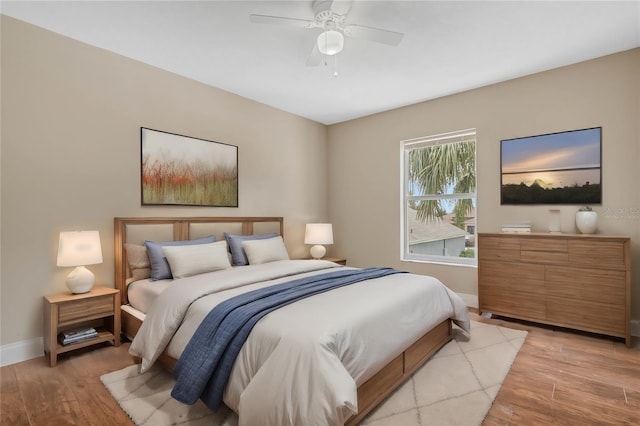 bedroom with light hardwood / wood-style flooring and ceiling fan