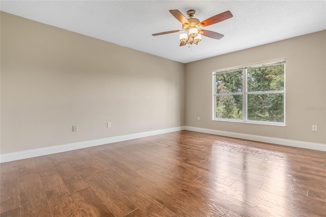 empty room featuring hardwood / wood-style flooring, ceiling fan, and a textured ceiling