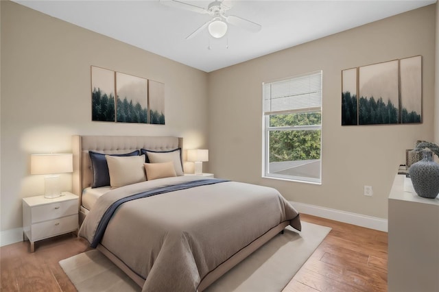 bedroom with ceiling fan and light hardwood / wood-style floors