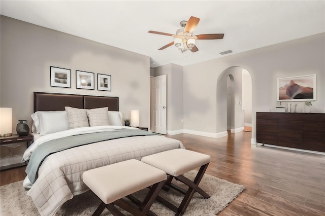 bedroom with dark hardwood / wood-style floors and ceiling fan