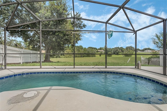 view of swimming pool with a patio, a yard, and glass enclosure