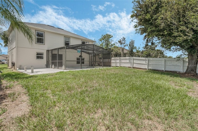 view of yard with a patio and glass enclosure