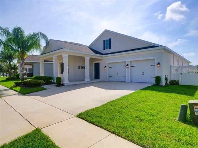 view of front of house featuring a garage and a front lawn