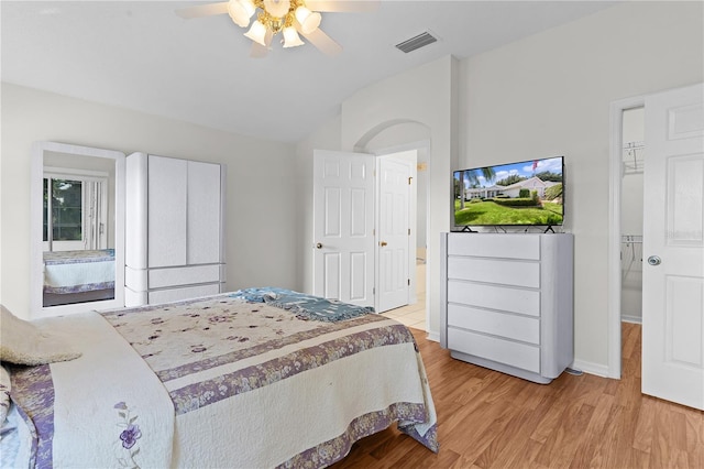 bedroom with light hardwood / wood-style flooring, ceiling fan, and lofted ceiling