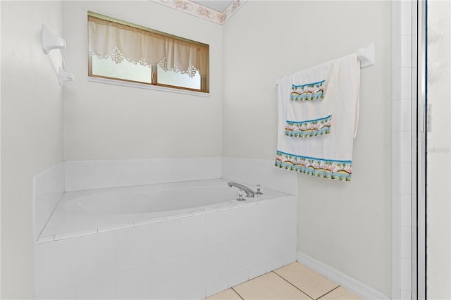 bathroom featuring tile patterned flooring and tiled tub