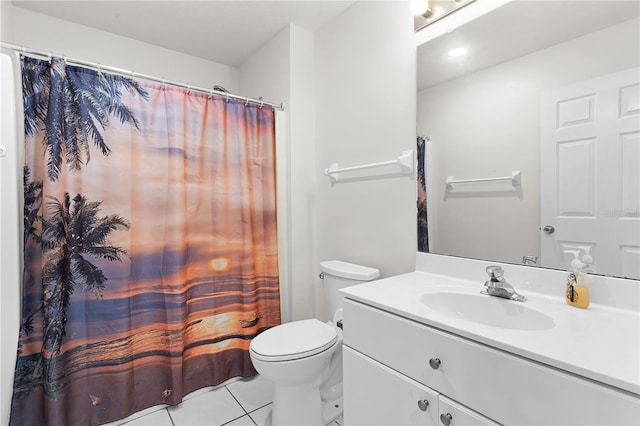 bathroom with tile patterned flooring, vanity, and toilet