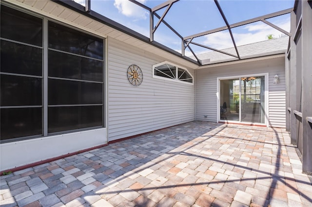 view of patio featuring glass enclosure