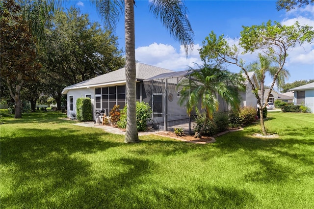 exterior space featuring a lanai and a yard