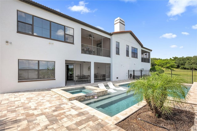 rear view of house with a patio, fence, a chimney, and stucco siding