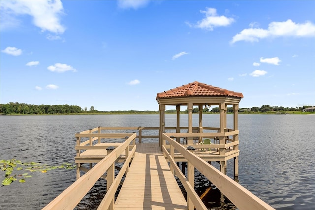 view of dock with a gazebo and a water view