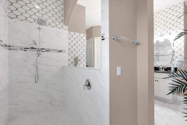 bathroom featuring a marble finish shower