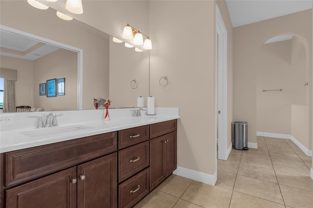 bathroom featuring double vanity, a sink, and tile patterned floors