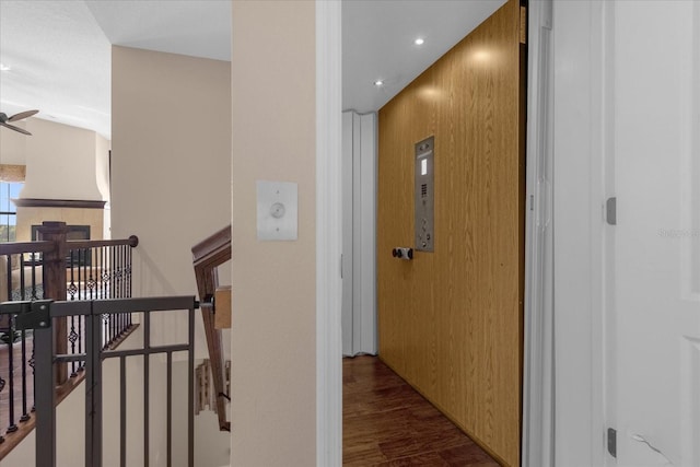 corridor featuring recessed lighting, an upstairs landing, and wood finished floors