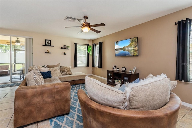 living room featuring ceiling fan and light tile patterned floors