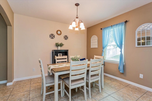 tiled dining area with an inviting chandelier