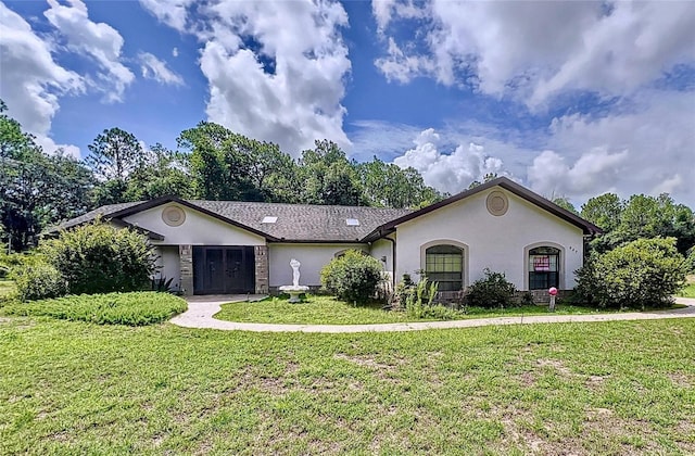 ranch-style home with a front lawn