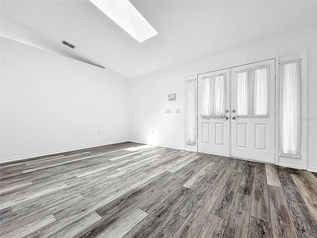 interior space featuring a skylight and wood-type flooring