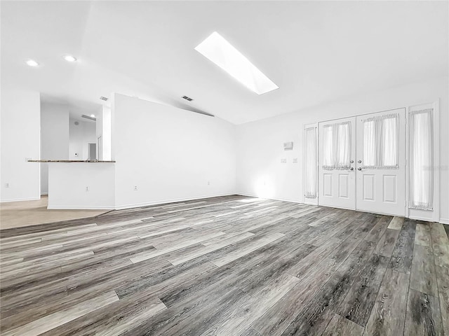 unfurnished living room with french doors, hardwood / wood-style flooring, and a skylight