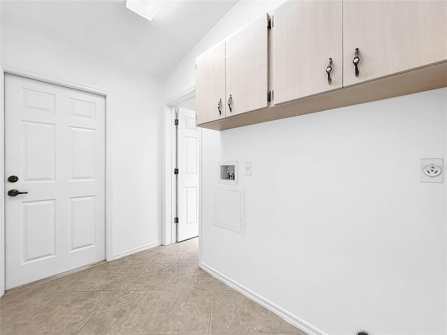 laundry area with cabinets, light tile patterned flooring, and washer hookup