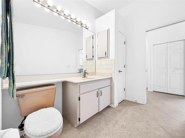 bathroom with tile patterned floors, toilet, and vanity