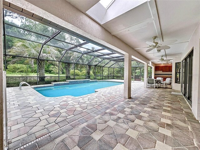 view of swimming pool with ceiling fan, a patio area, and a lanai