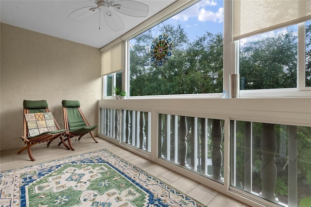 sunroom / solarium featuring ceiling fan