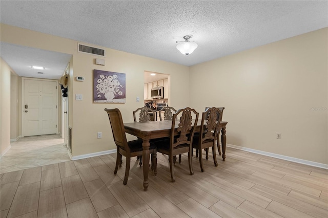 dining room with a textured ceiling