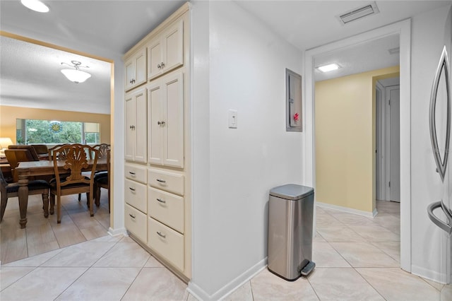 hall with light tile patterned floors