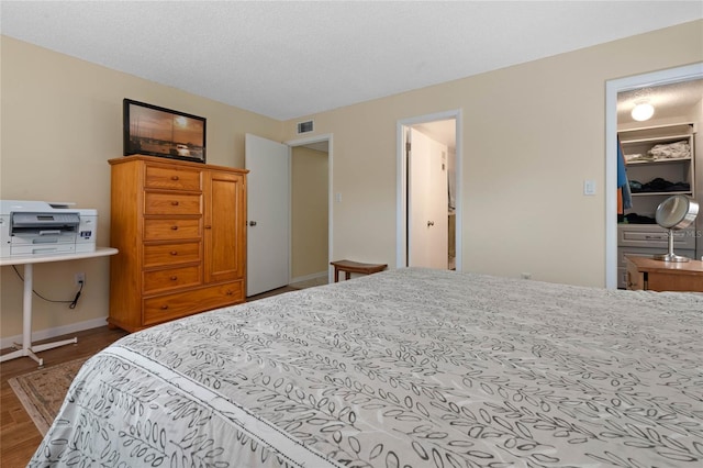 bedroom with hardwood / wood-style flooring and a textured ceiling