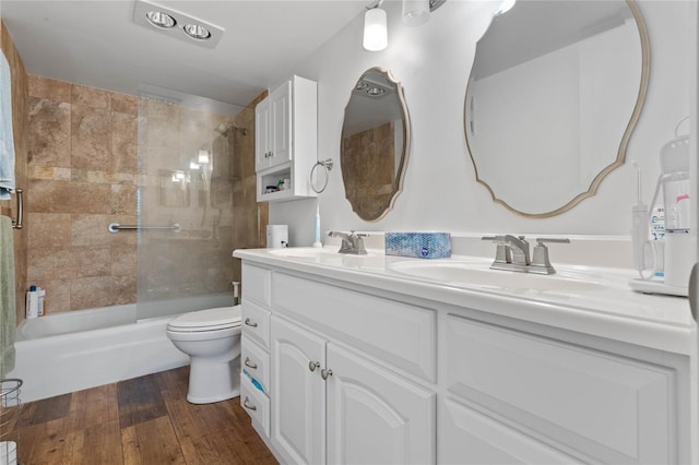 full bathroom featuring enclosed tub / shower combo, wood-type flooring, vanity, and toilet