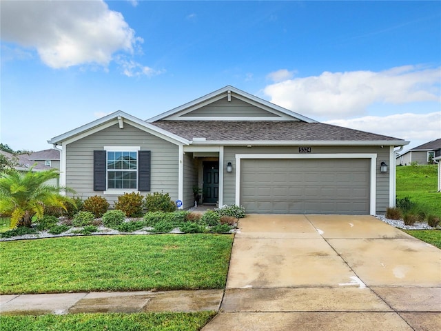 view of front of property featuring a garage and a front lawn