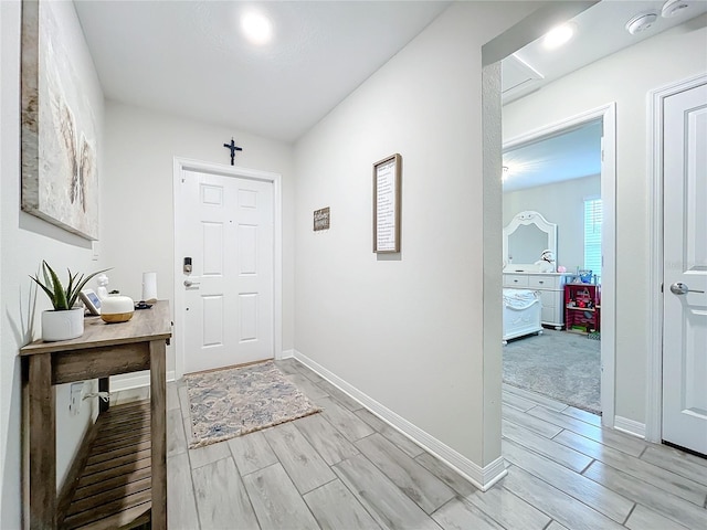 foyer entrance featuring light colored carpet