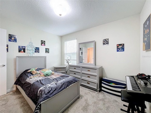 carpeted bedroom featuring a textured ceiling