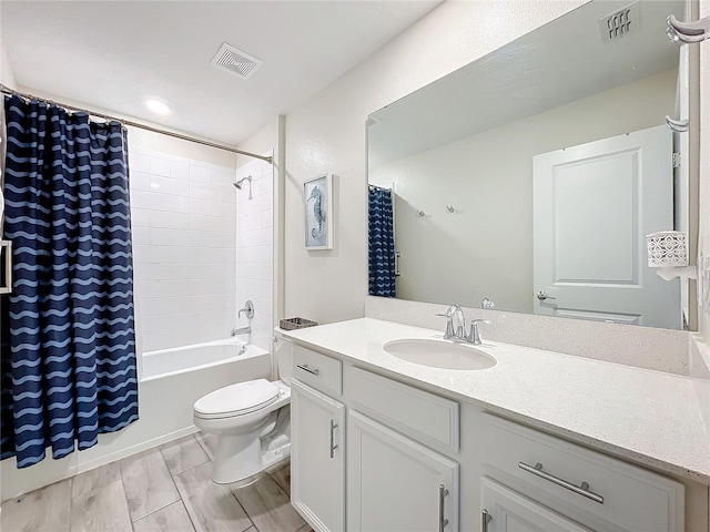 full bathroom featuring shower / bath combination with curtain, toilet, and vanity