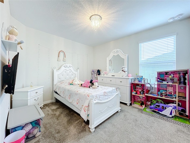 bedroom with a textured ceiling and light colored carpet