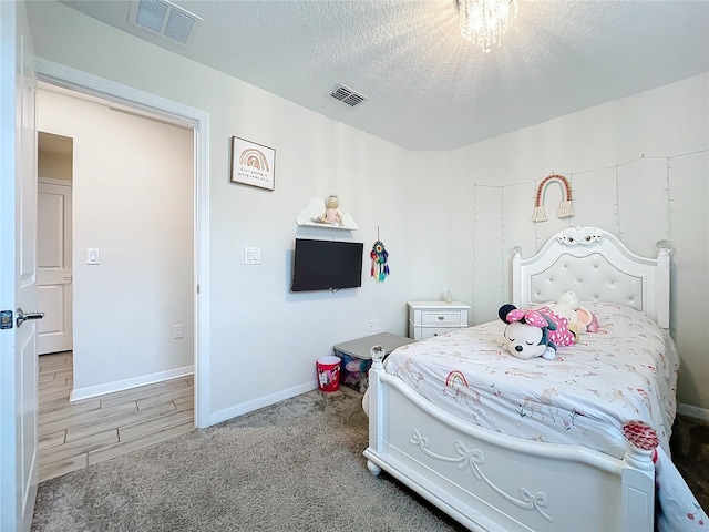 carpeted bedroom with a textured ceiling