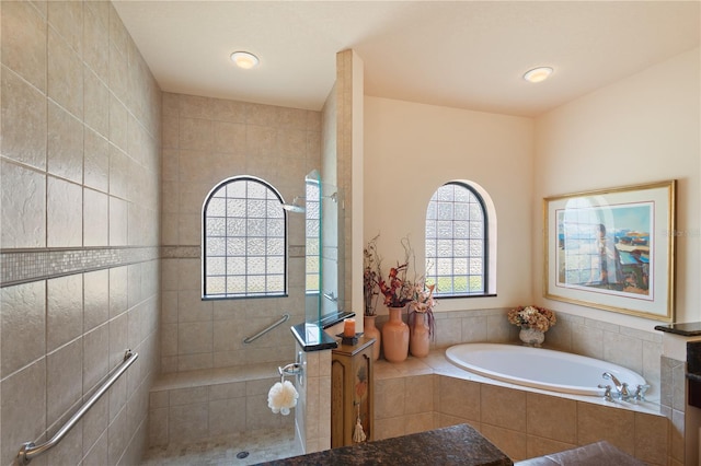 bathroom featuring separate shower and tub